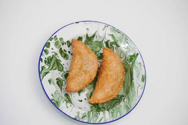 stock image The market snack is called pastel cake which is in a container with a white background