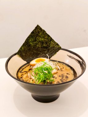 Japon yemeği konsepti. Tonkotsu Ramen, yosun, domuz eti, haşlanmış yumurta ve yeşil soğanlı.. 