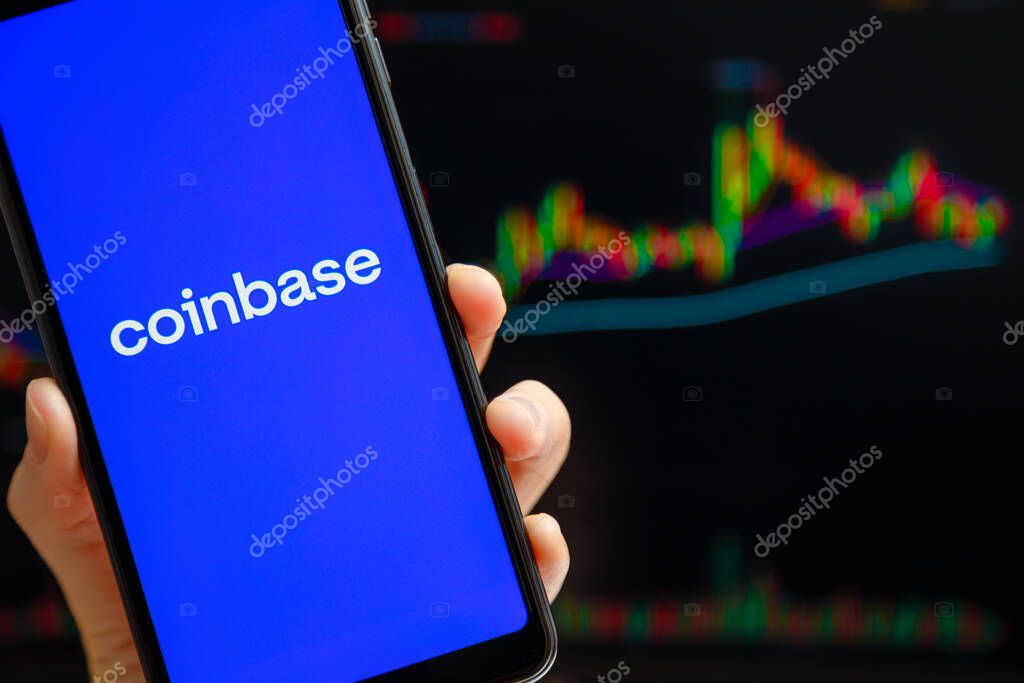 Ukraine, Odessa - October, 9 2021: Coinbase mobile app running at smartphone screen with trading candlestick chart at background. Coinbase is American cryptocurrency exchange and trading platform
