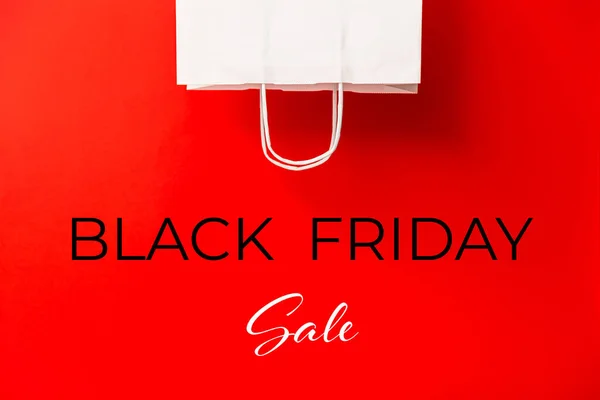 stock image Black Friday sale. Blank white paper bag isolated on red background. Discount, recycling, shopping and ecology concept.