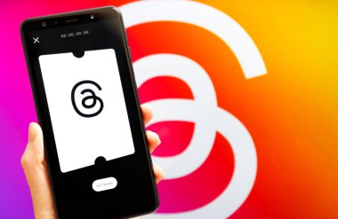 Ukrayna, Odesa - Temmuz 7 2023: Akıllı telefon ekranında çalışan Tehlike uygulaması ile el ele tutuşma cep telefonu. Tartışmalar, Meta Platformları 'nın sahibi olduğu çevrimiçi sosyal medya hizmeti. Twitter yarışmacısı.