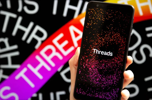 stock image Ukraine, Odesa - July, 7 2023: Hand holding mobile with Threads app running at smartphone screen. Threads is online social media service owned by Meta Platforms. Twitter competitor.