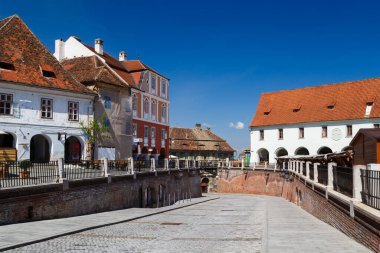 Sibiu, Transilvanya, Romanya - 2 Mayıs 2022: Yalanlar Köprüsü veya Sibiu 'nun tarihi merkezi Küçük Meydan veya Piata Mica' daki Podul Minciunilor 'a giden yol. Parlak güneşli bir gün.