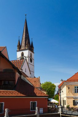 Sibiu, Transilvanya, Romanya - 2 Mayıs 2022: Sibiu Lutheran Saint Mary Katedrali 'nin çan kulesi ve Sibiu' nun tarihi merkezi Yalanlar Köprüsü.