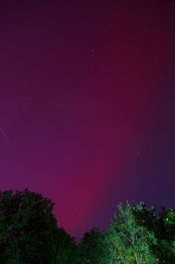Ukrayna 'nın güneyindeki Odessa şehrinde gece gökyüzünde kırmızı renkli Aurora Borealis veya Kuzey Işıkları. Güneş maksimumu sırasında düşük enlemlerde Aurora.