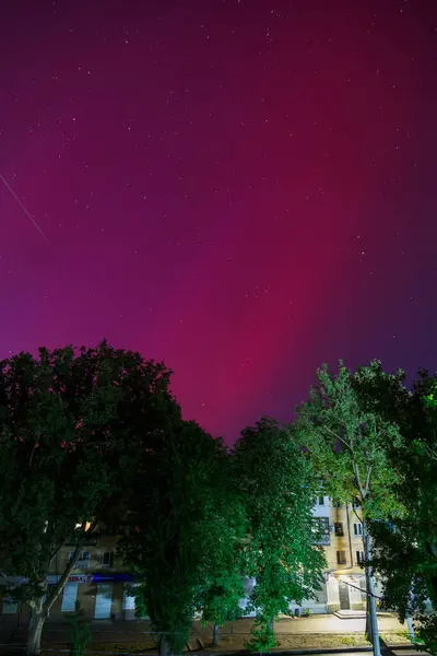 stock image Odesa, Ukraine - May 11, 2024: Red-colored Aurora Borealis or Northern Lights in night sky over Odessa city, southern Ukraine. Aurora in low latitudes during solar maximum