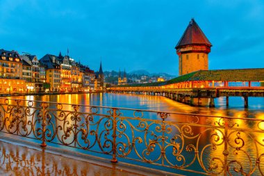 Beautiful historic city of Lucerne with famous Chapel Bridge and Water Tower at twilight time , Switzerland clipart