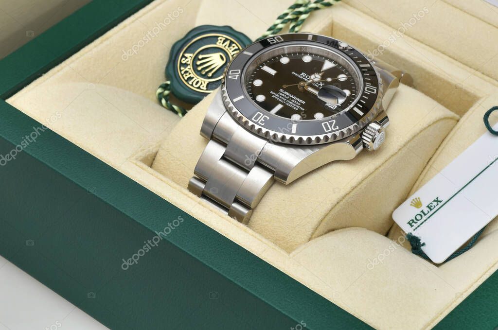 Bangkok Thailand- January 28,2021: Rolex Submariner Date Steel Black on Rolex green box crown logo , coin manual book