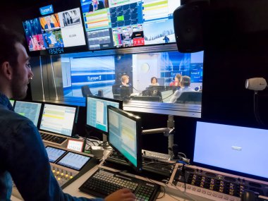 PARIS, FRANCE- NOVEMBER Circa, 2019. Technical room with audio mixing console, computers, tv led, screens and studio equipment in recording, broadcasting, editing studiio.