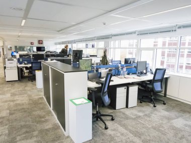 PARIS, FRANCE - NOVEMBER Circa, 2019. Exciting boardroom meeting with people at desk with computer in trendy office space, at Europe 1, radio recording studio.