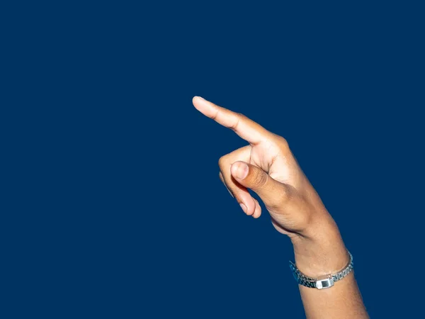 Close up of a young indian woman hand pointing finger as touching screen, isolated on blue background. Innovation technology internet business concept background for graphic designer