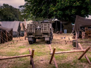 SAINTE MERE L'EGLISE, NORMANDY, FRANCE - JUNE 6 2023. Second world war commemoration. Military camp reconstitution Tents, military american war trucks. clipart