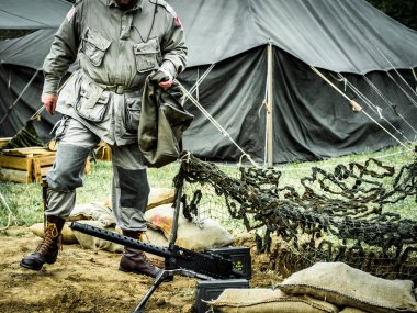 Aziz Michael L 'Eglise, Normandiya, Fransa - 6 Haziran 2023. İkinci Dünya Savaşı anısına. Askeri kamp anayasası. Makineli tüfekli kimliği belirsiz askerler..