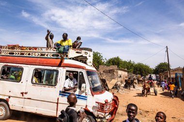 Bour, Senegal - CIRCA Mart 2021. Tanımlanamayan ciddi bir şekilde korkmuş fakir Afrikalı çocuklar ve köydeki gençler kameraya bakıyorlardı..