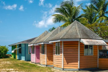Colorful huts by yhe beach in the Pigeon Point beach klub park in brite sunny day. Tobago Island. Carribean.,