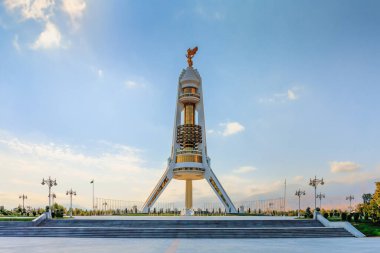 Ashgabat Turkmenistan - October 10 2019: Monument of Neutrality, the three-legged arch built with white marble, gold details and gold-plated statue of Niyazov. clipart