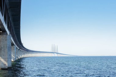 The Oresund Bridge over the Batlic sea, linking Malmo to Copenhagen , view from Sweden. Concepts: connection, travel, transportation clipart