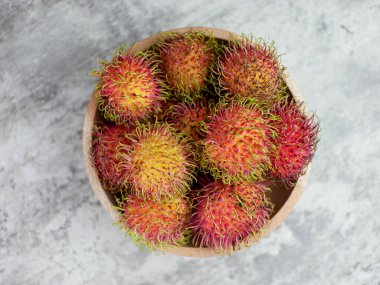 Fresh and ripe rambutan fruit on basket