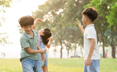group image of cute asian children playing in the park