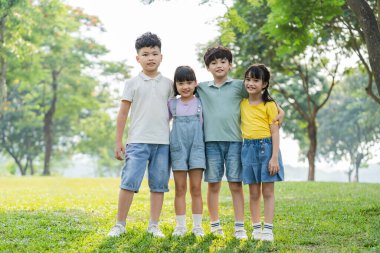group of cute asian kids having fun in the park