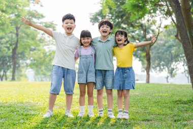 group of cute asian kids having fun in the park