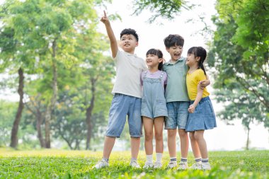 group of cute asian kids having fun in the park