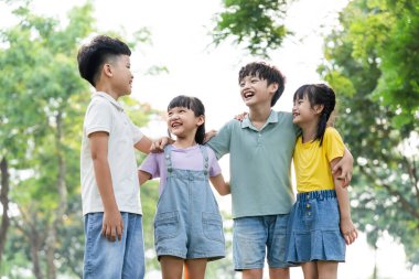 group of cute asian kids having fun in the park
