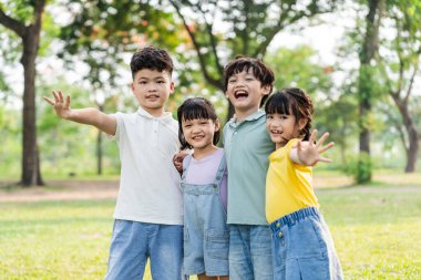 group of cute asian kids having fun in the park
