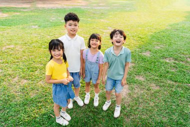 group of cute asian kids having fun in the park