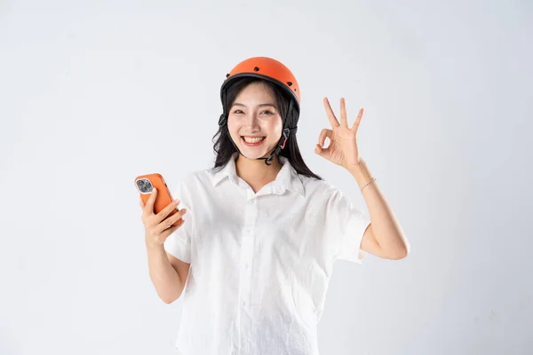 stock image woman wearing orange helmet on white background