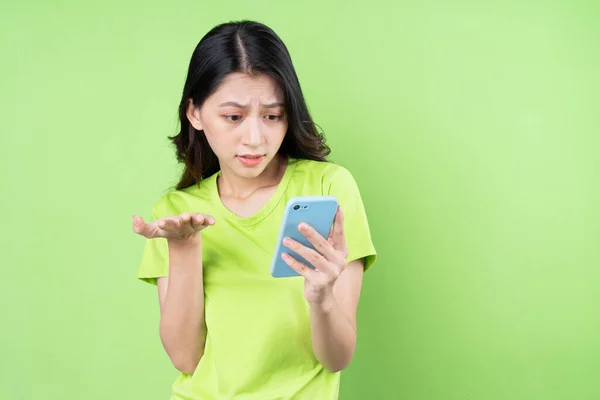 Image Young Asian Woman Holding Smartphone Green Background — Stock Photo, Image