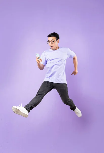 Portrait Jumping Asian Man Isolated Purple Background — Stock Photo, Image