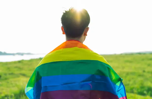 Abstract silhouette of gay man on shoulder is lgbt flag