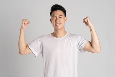 Beyaz arka planda poz veren Asyalı bir adamın portresi