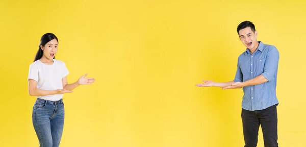 Image of asian couple posing on yellow background
