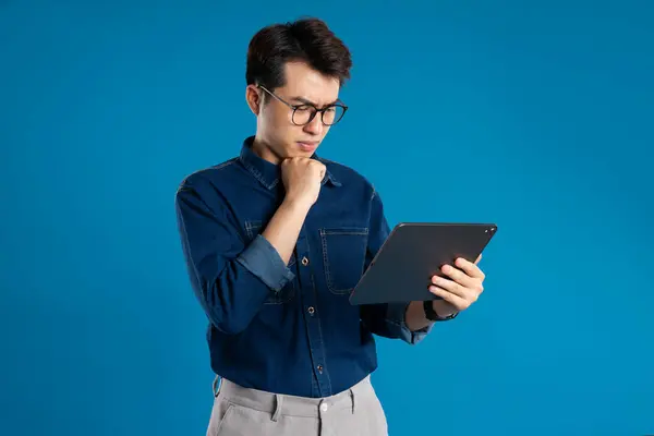 stock image Portrait of young Asian business man posing on blue background