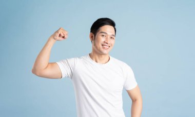 Asian male portrait posing on blue background clipart