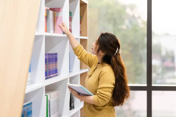 stock image portrait of Asian female student studying at university library