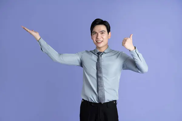stock image Portrait of Asian male businessman posing on purple background