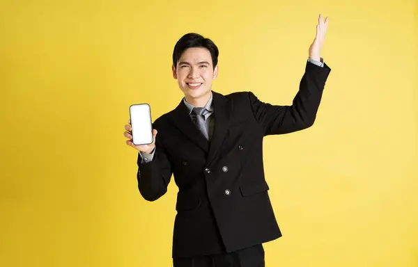 アジアの男性ビジネスマンの肖像画 スーツを着て黄色の背景にポーズをかける — ストック写真