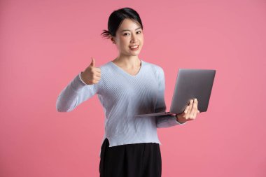 Portrait of beautiful asian woman posing on pink background clipart