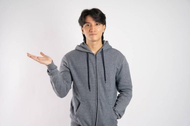 Portrait of asian man wearing hoodie posing on white background clipart