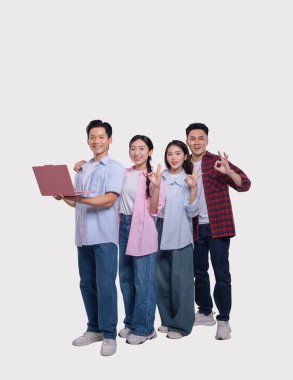 Bir grup sıradan giyinmiş genç yetişkin gülümseyip poz veriyor.