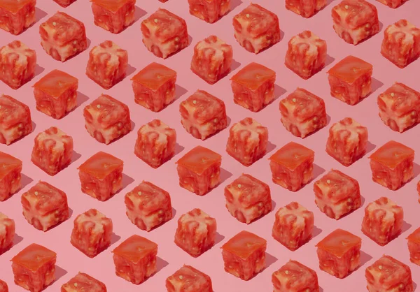 Pattern on a pastel background made of diced tomatoes. Fruits in a conceptual set.