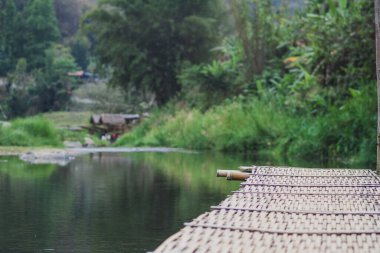 bamboo bridge and river at Utaradit, Thailand.