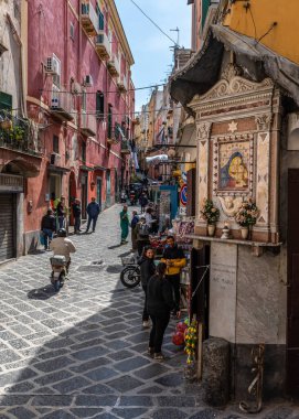 Procida 'da tipik dükkanlarla dolu renkli yaya caddesi. Procida, Campania, İtalya, Mart. 2023