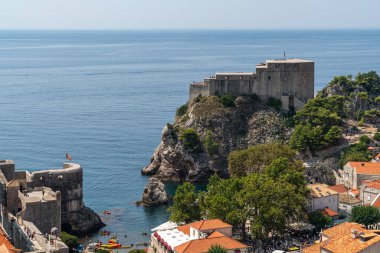 This photo captures a view of Dubrovnik city featuring Fort Lovrijenac in the background, showcasing the city historical charm, Croatia