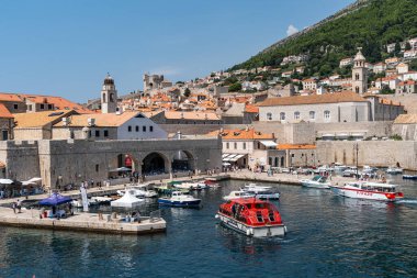 Dubrovnik, Croatia, Aug. 2023. Bustling old town harbor in filled with numerous boats, against the backdrop of the city.