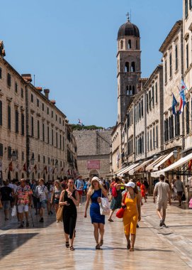 Dubrovnik, Croatia, Aug. 2023. Group of girls walking down a Stradun street lined with historic buildings