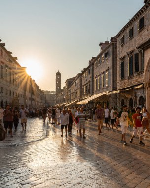 Dubrovnik, Croatia, Aug. 2023. Group of tourists making their way down the Stradun street lined with historic buildings